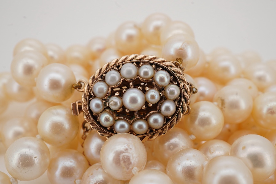 A double strand cultured pearl necklace, with a 9ct gold and cultured pearl cluster set clasp, pearl diameter approximate range 8.4mm-9mm.